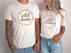 a man and woman standing next to each other wearing t - shirts with the words wild mama printed on them