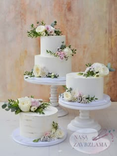 three tiered wedding cakes with flowers on them