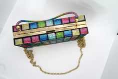 This versatile bag is a clutch, purse and over the shoulder. Its hard exterior makes it durable and is cover in colorful rhinestones. This is definitely a statement piece. Multicolor Crossbody Clutch For Evening, Multicolor Rectangular Clutch With Rhinestones, Multicolor Crossbody Clutch For Party, Multicolor Rectangular Shoulder Bag For Evening, Multicolor Shoulder Bag Clutch For Party, Multicolor Rectangular Evening Bag With Rhinestones, Multicolor Rectangular Evening Shoulder Bag, Multicolor Rhinestone Shoulder Bag For Party, Multicolor Rhinestone Rectangular Evening Bag