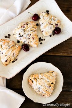 three scones on a plate with cherries and chocolate chips