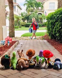 a group of stuffed animals sitting on top of a sidewalk