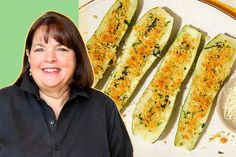 a woman standing in front of a plate of food with zucchini on it