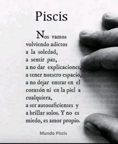 a person holding their hand over a piece of paper with the words piscis written in spanish