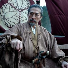 an old man dressed in traditional chinese costume