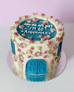 a decorated birthday cake with flowers on the frosting and blue lettering that says, i'm 20 th anniversary