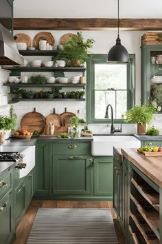 a kitchen filled with lots of green cupboards and counter top space next to a window