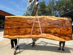 a man is holding a large piece of wood