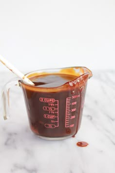 a measuring cup filled with liquid on top of a table