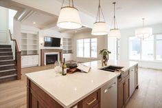 a large kitchen with an island and fireplace