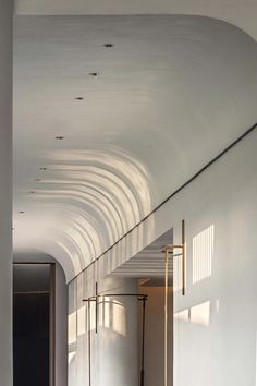 an empty room with white walls and flooring is seen in this image from the hallway