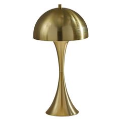 a brass colored table lamp with a large dome shade on the top, and a white background