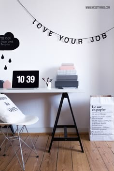 a white desk topped with a laptop computer next to a black and white sign that says we are your job