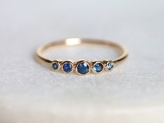 Blue sapphire ring, Blue sapphire stacking ring, dainty ring, stacking ring, stackable ring, blue sapphire ring, Sapphire ring Available in 9k/14k/18k yellow, rose or white gold. Same design can be made also with other custom gemstones per request. Product details: - Solid gold - approx 2.5, 2, 1.5 mm sapphire round - Band size is 1.2mm Ring size - US 3 to US 9 (for smaller or larger ring size, please contact) Please select your size at the drop down menu. Service Available - Customization Avail Blue Fine Jewelry Stackable Rings With Bezel Setting, Blue Sapphire Stackable Rings For Promise, Blue Bezel Set Stackable Rings Fine Jewelry, Adjustable Blue Sapphire Ring Fine Jewelry, Handmade Fine Jewelry Blue Rings, Blue Sapphire Ring With Bezel Setting For Promise, Blue Adjustable Stackable Rings, Fine Jewelry, Adjustable Blue Stackable Rings, Fine Jewelry, Adjustable Blue Stackable Rings For Anniversary