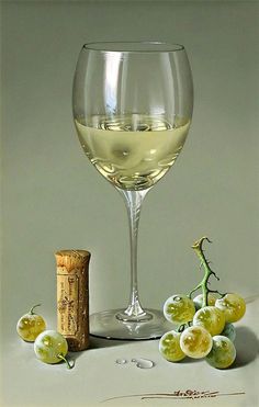 a glass of white wine next to some grapes and a cork