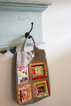 a bag hanging from a hook on a wall next to a blue painted window frame