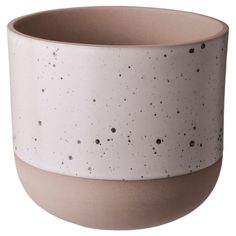 a white and brown ceramic bowl with speckles on the outside, in front of a white background