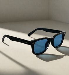 Expertly designed with a classic wayfarer style, the Icon sunglasses offer 100% UV protection with its black acetate frame and blue lenses. The square frame gives a sleek and modern look, making them perfect for any occasion. Add a touch of sophistication to your wardrobe with the Icon style sunglasses. Unisex. Blue Wayfarer Sunglasses With Mirrored Lenses, Classic Blue Sunglasses With Uva Protection, Blue Mirrored Lenses Square Frame Sunglasses, Casual Blue Everyday Sunglasses, Blue Square Frame Sunglasses With Tinted Lenses, Blue Sunglasses With Gradient Lenses For Everyday, Blue Square Frame Sunglasses With Mirrored Lenses, Classic Blue Sunglasses With Polarized Lenses, Retro Blue Wayfarer Sunglasses