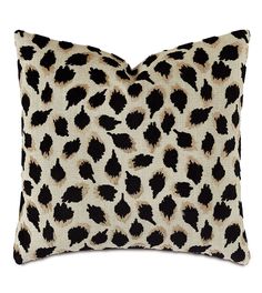 a leopard print pillow with black and brown spots on the front, sitting on a white background