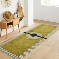 a green area rug with an image of a guitar on it in front of a white wall