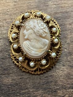 Signed FLORENZA Vintage retro ornate gold tone seed Pearl & carved shell CAMEO brooch with roll clasp Ornate Carved Gold Brooches, Ornate Gold Carved Brooches, Vintage Gold Carved Brooches, Collectible Carved Gold Brooches, Antique Gold Cameo Brooch, Antique Gold Cameo Brooches, Carved Shell, Cameo Brooch, Seed Pearl