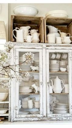 an old china cabinet is filled with dishes