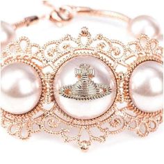 This women's bracelet comes in imitation pink gold with a grosgrain texture and scalloped edges.Rose gold-tone bracelet.Lobster clasp closure.Faux pearl accents.Intricate scroll work and signature Orb emblem.MeasurementsWidth: 3 ⁄ 5 ". Diameter/Length: 8"Charm Length: 1 1 ⁄ 2". Charm Width: 2"Made in Italy Luxury Adjustable Pearl Bracelet For Party, Luxury Metal Bracelets For Wedding, Luxury Rose Gold Pearl Jewelry, Elegant Pink Jewelry As Fashion Accessory, Luxury Rose Gold Party Bracelets, Elegant Pink Gold Metal Bracelets, Luxury Adjustable Pearl Bracelet For Formal Occasions, Luxury White Jewelry For Fashion Accessory, Elegant Pink Gold Metal Bracelet