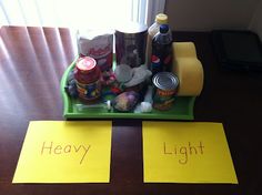 two pieces of yellow paper sitting on top of a table next to bottles and cans