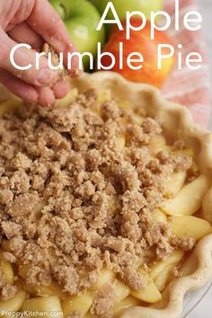 an apple crumble pie is being made with apples in the background