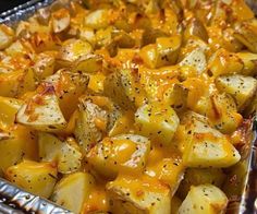 potatoes with cheese and seasoning in a pan