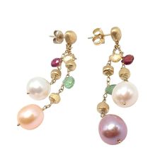 About This Piece: The Marco Bicego Paradise earrings are a vibrant celebration of luxury, crafted from 18k yellow gold. These exquisite earrings feature a delightful array of multicolor gemstones, complemented by elegant pearls. Hand-engraved with precision, the gold offers a textured, matte finish, showcasing Bicego's renowned craftsmanship and unique design ethos. Metal: 18k Yellow Gold Measurements: 7mm x 57mm Weight: 9.2 grams Stone: 6x Briolette cut color stones 4x Different hue pearls appr Marco Bicego, Color Stones, Hand Engraving, Cut And Color, Stone Color, Unique Design, Paradise, Pearl Earrings, Unique Designs