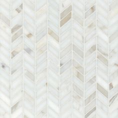 white marble herringbone tile with grey and beige tones on the bottom half of it