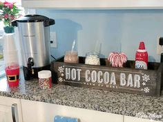 a hot cocoa bar sign sitting on top of a counter