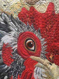 a close up view of a red and black rooster