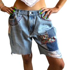 Vintage Levi's jorts with patches and embroidery.  Seen  here on a size 24/25 size S.  The perfect amount of baggy.  Waist  made smaller with added buttons.  Upcycled by Ére from all thifted materials. Measurements: Waist 15" buttoned once, 14" buttoned 2 times, not buttoned 17.25" Rise 11" inseam 9" Casual Upcycled Bottoms For Spring, Bohemian Cotton Bottoms With Patches, Casual Denim Bottoms With Embroidered Patch, Casual Upcycled Cotton Bottoms, Short Cotton Bottoms With Patches, Blue Cotton Bottoms With Patches, Cotton Bottoms With Patches In Short Length, Vintage Bottoms With Patches For Summer, Casual Cotton Shorts With Patches