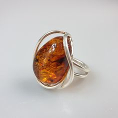 Amber ring. Sterling silver 925 genuine Amber ring. With hallmark. Brown colour available. Adjustable size Stone size 2.5 x 3 cm. Weight 9.52 gr. This item was made of natural Baltic Amber. All the amber used in my jewelry is collected in my home country Lithuania. I sell only genuine, authentic, real, natural Baltic Amber. Item may have natural imperfections. Due to amber being natural, each of my jewelry is unique and even the same models can be slightly different. Please contact me for more d Amber Wedding Rings With Polished Finish, Unique Amber Sterling Silver Rings, Baltic Amber Ring Jewelry Gift, Handmade Baltic Amber Ring, Handmade Baltic Amber Jewelry, Adjustable Sterling Silver Amber Ring, Adjustable Sterling Silver Ring With Amber Color, Minimalist Amber Ring Jewelry, Baltic Amber Ring For Anniversary