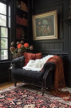 a living room with black walls and rugs on the floor, an old chair in front of a window