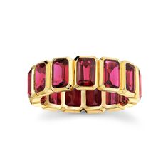 an 18k yellow gold ring set with rubish cut red tourmaline stones