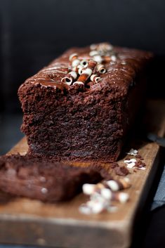 there is a piece of chocolate cake on the cutting board