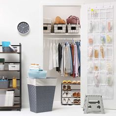 an organized closet with clothes, shoes and other items on shelves next to a clock