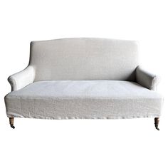 a white couch sitting on top of a wooden frame