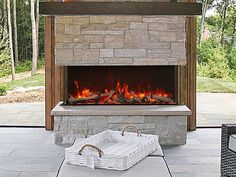 an outdoor fireplace with a basket on it