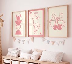 three framed pictures hang on the wall above a wooden bench with pillows and stuffed giraffe