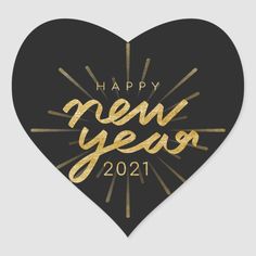 a heart shaped sticker with the words happy new year in gold foil on it