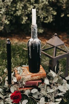 a candle and some books in the grass