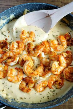 a skillet filled with shrimp and cream sauce