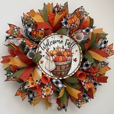 a welcome fall wreath hanging on the wall