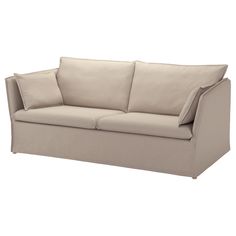 a beige couch with two pillows on the back and one arm folded over it's head