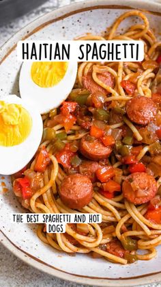 a plate full of spaghetti with sausage, peppers and hard boiled eggs