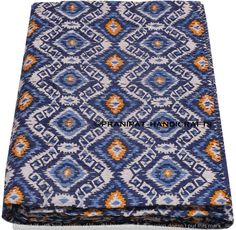 a blue and orange patterned blanket on a white background