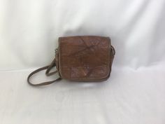 "Vintage 80's patched leather cocoa/cappuccino brown handmade purse, crossbody bag. Retro design purse boho casual rustic ladies accessories. Inside is textile lining, 1 large compartment, 1 frontal open way pocket and 1 zippered back compartment. condition: great vintage. Has small scratches on the leather surfaces around the magnetic closure (on bottom). Without seriously damages. measurements: height: 16,5 cm / 6.4\" in width: 21 cm / 8.2\" in strap length (no adjustable): 130 cm / 50.7\" in" Brown Satchel With Cell Phone Pocket, Vintage Brown Flap Shoulder Bag, Vintage Brown Crossbody Flap Bag, Vintage Brown Flap Bag, Vintage Brown Flap Bag For Travel, Brown Medium Shoulder Bag For Everyday, Medium Brown Shoulder Bag For Everyday, Everyday Medium Brown Shoulder Bag, Vintage Brown Bag With Cell Phone Pocket